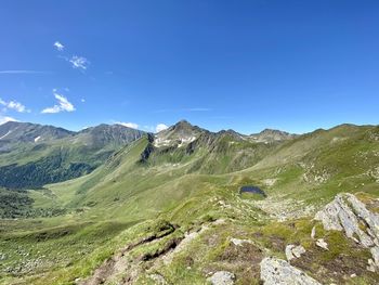 Scenic view of mountains against clear blue sky