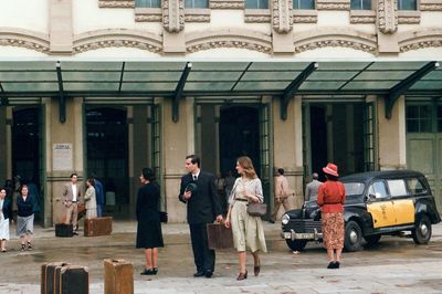 People walking on street against buildings in city