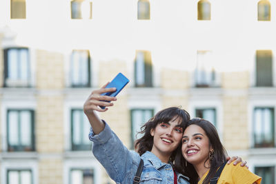 Portrait of young woman using mobile phone