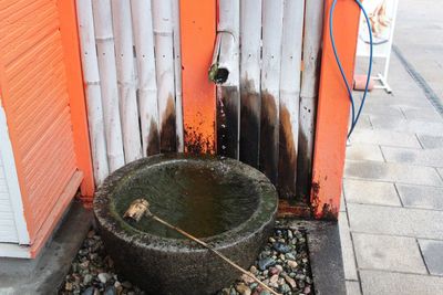 High angle view of metal pipes on footpath at entrance