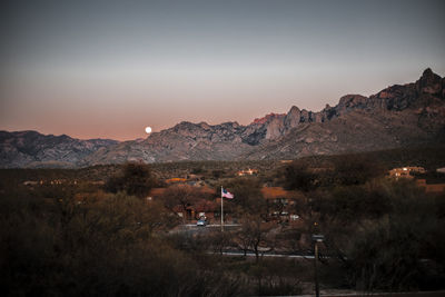 Scenic view of illuminated mountains against sky at night