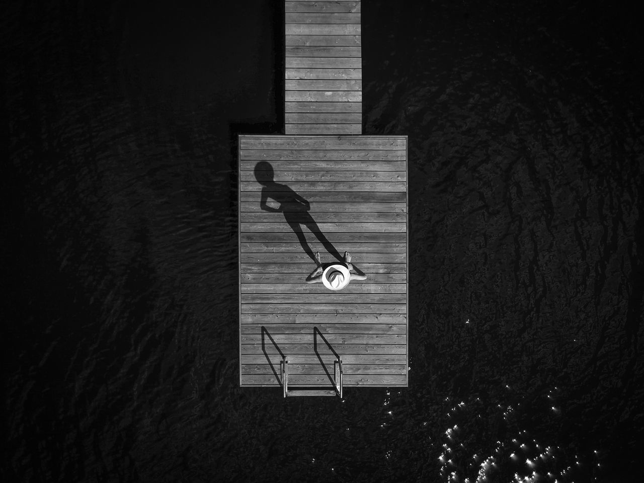 HIGH ANGLE VIEW OF PERSON WITH SIGN ON ROAD