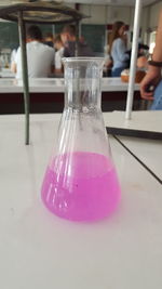 Glass of pink juice on table in restaurant