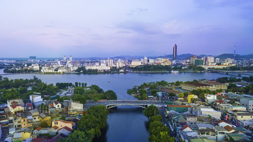 High angle view of river and buildings against sky