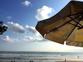 View of calm beach against blue sky