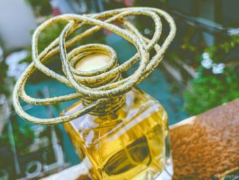 High angle view of cable wrapped on bottle against swimming pool