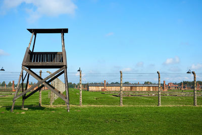 Lifeguard hut on field against sky
