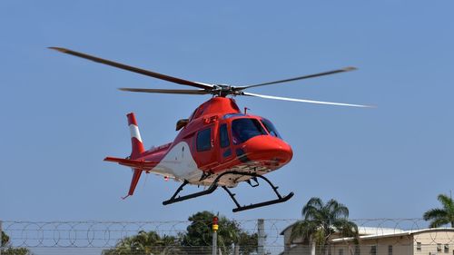 Low angle view of airplane against clear blue sky