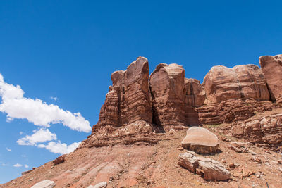 Low angle landscape of massive red boulders forming a wall in bluff, utah