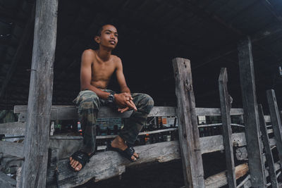 Portrait of young man sitting on seat