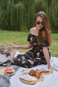 Young woman sitting on table