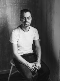 Portrait of man sitting on floor