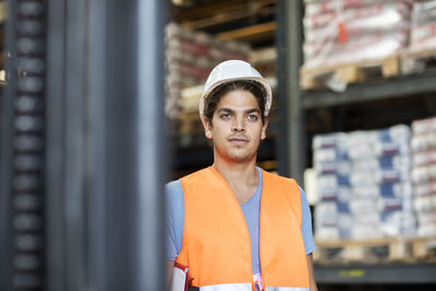 Young store worker with helmet working in a store