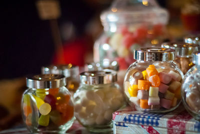 Close-up of sweet food in glass jars on table