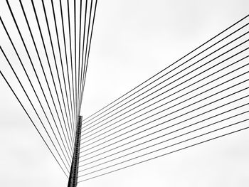 Low angle view of suspension bridge against sky