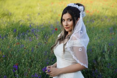 Young woman standing amidst flowers