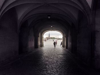 Woman walking in tunnel