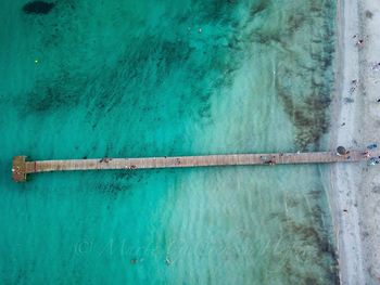 High angle view of pipe by swimming pool against sea