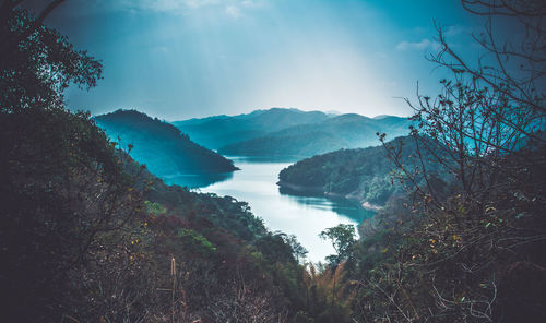 Scenic view of lake and mountains against sky