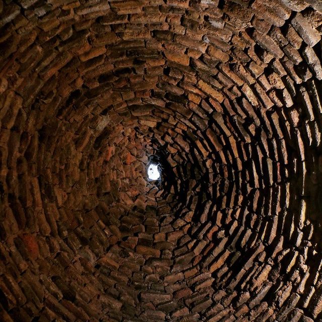 indoors, ceiling, circle, built structure, tunnel, architecture, arch, pattern, illuminated, full frame, old, lighting equipment, backgrounds, no people, textured, diminishing perspective, history, the way forward, brick wall, stone wall