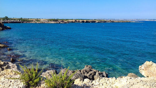 Scenic view of sea against clear blue sky