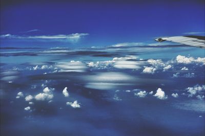 Aerial view of landscape against blue sky