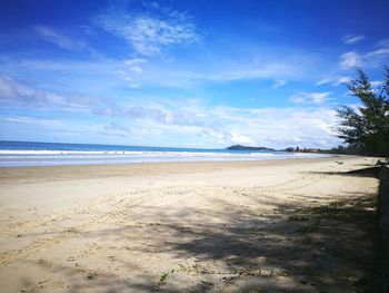 Scenic view of beach against blue sky