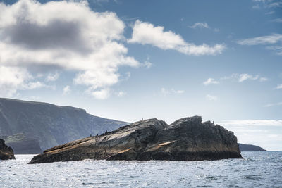 Scenic view of sea and mountains against sky