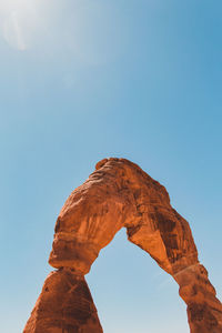 View of natural arch against clear sky during sunny day