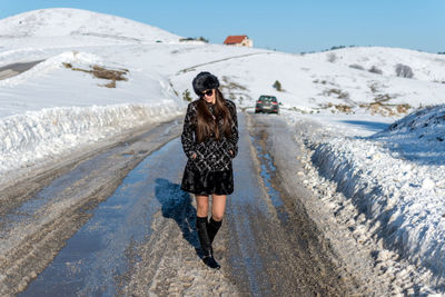 Full length of woman standing on snow