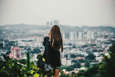 Woman photographing cityscape