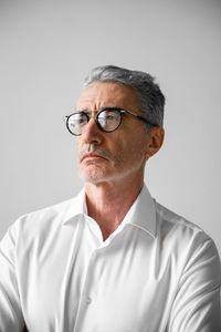 Thoughtful businessman against gray background