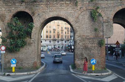 People walking on road along buildings