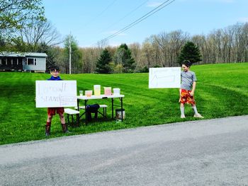 Rear view of people walking on field