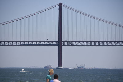 View of suspension bridge over sea