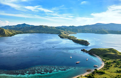 High angle view of sea and mountains against sky