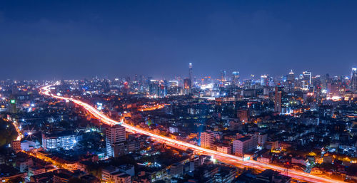 High angle view of illuminated city buildings at night