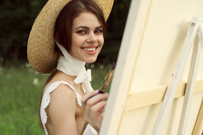 Portrait of young woman wearing hat