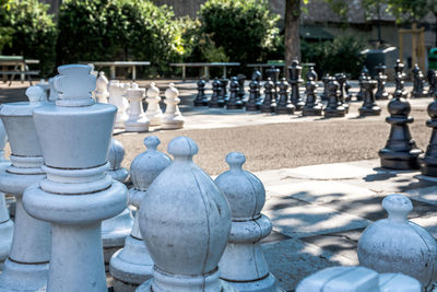 Close-up of chess pieces on footpath