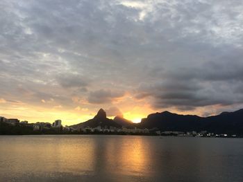 Scenic view of bay against sky at sunset