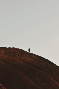 Low angle view of person standing on landscape