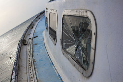 Close-up of broken window in sailboat on sea