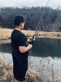 Young man fishing in lake