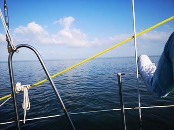 Sailboat sailing on sea against sky
