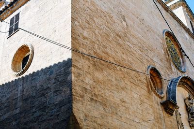 Low angle view of shoes hanging on wall