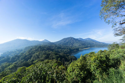 Scenic view of mountains against blue sky