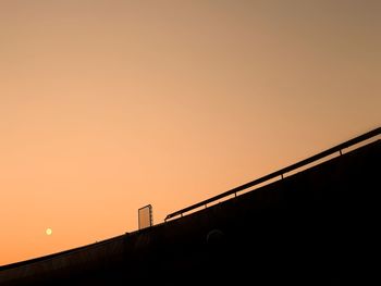 Low angle view of silhouette bridge against sky during sunset