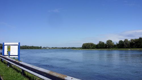 Scenic view of lake against clear blue sky