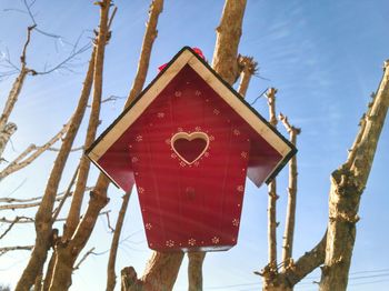 Low angle view of birdhouse on tree against sky