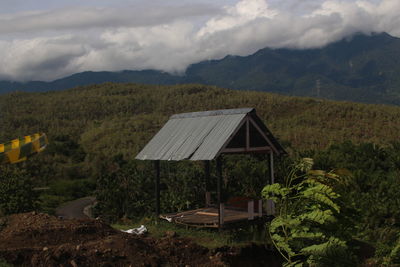 Built structure on landscape against sky